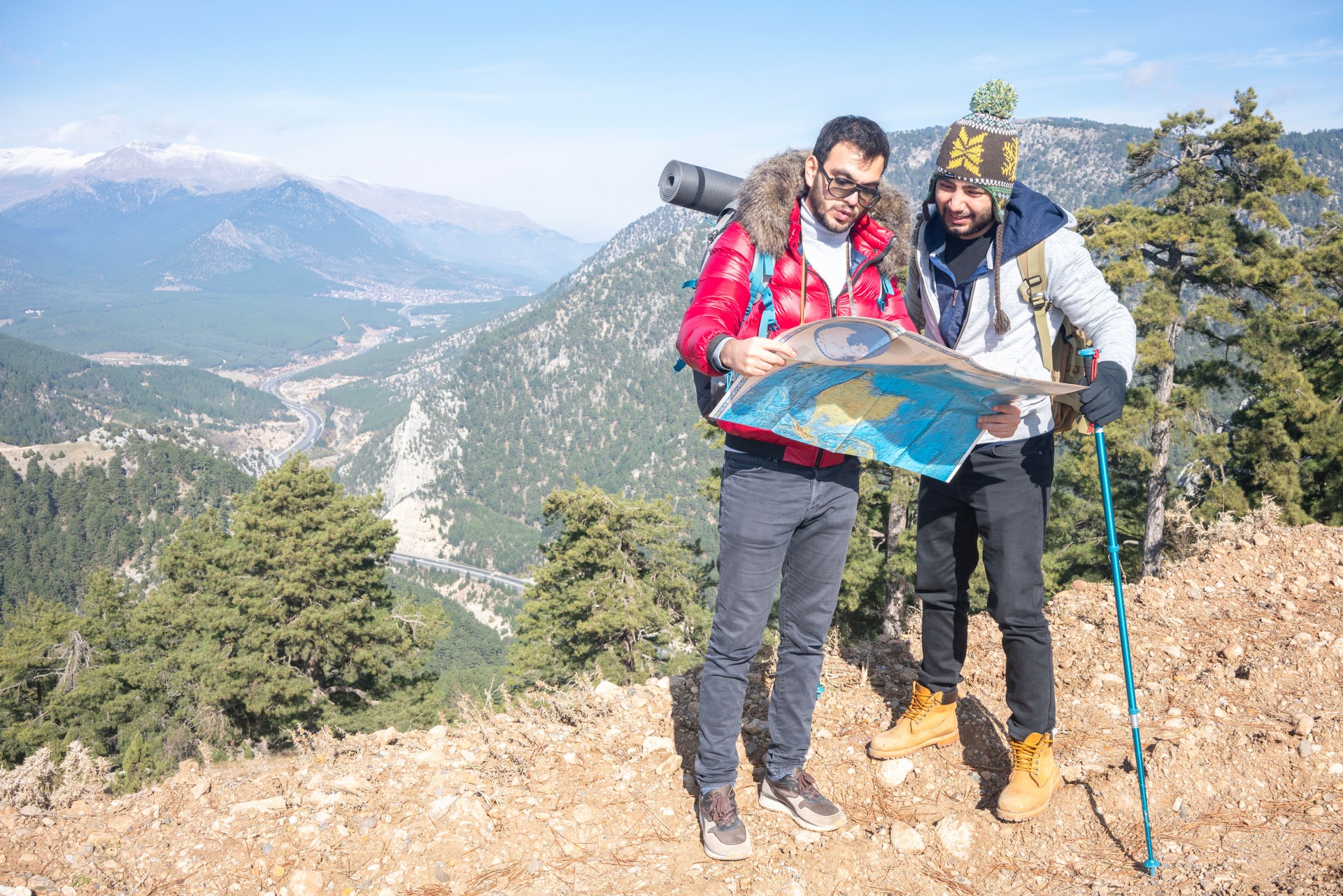 Hiking friends with map in mountain.